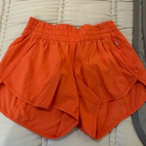 Lululemon orange shorts. Size 10. Never worn. 4 inch inseam.
